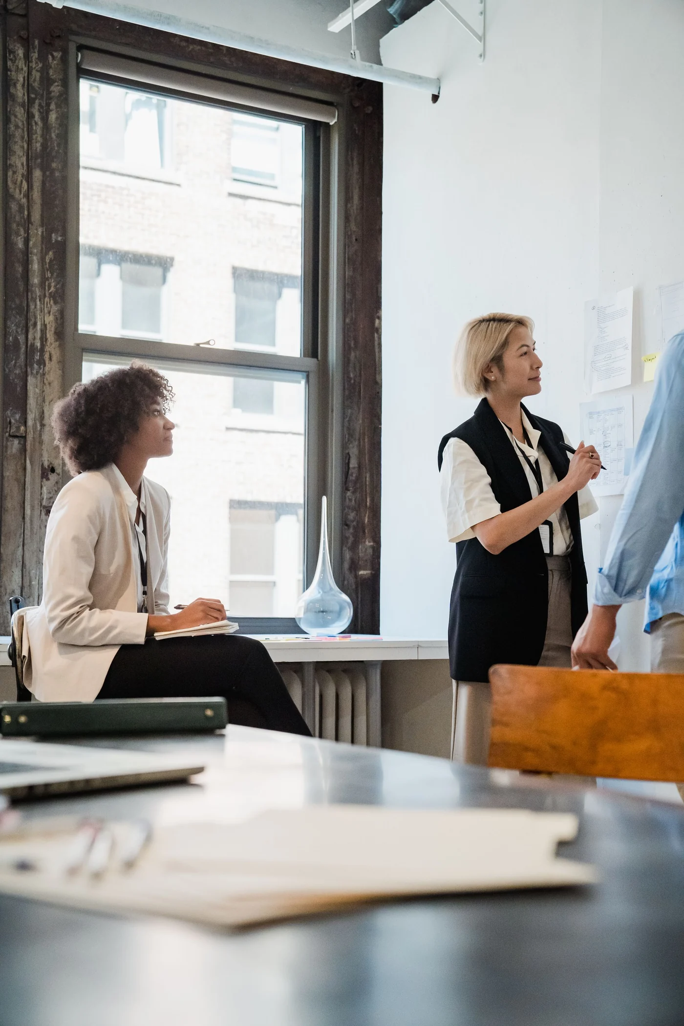 Professional team collaborating on a project in a well-lit office space.