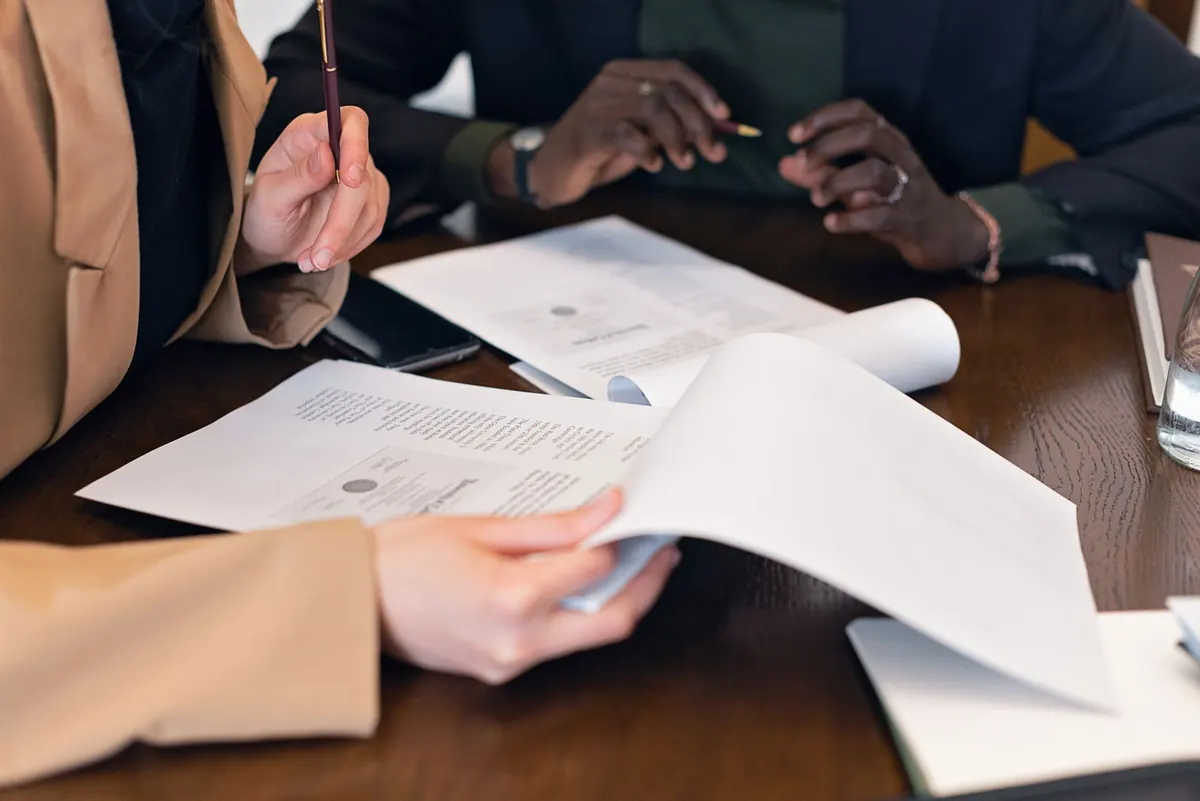 Professionals reviewing documents together at a meeting