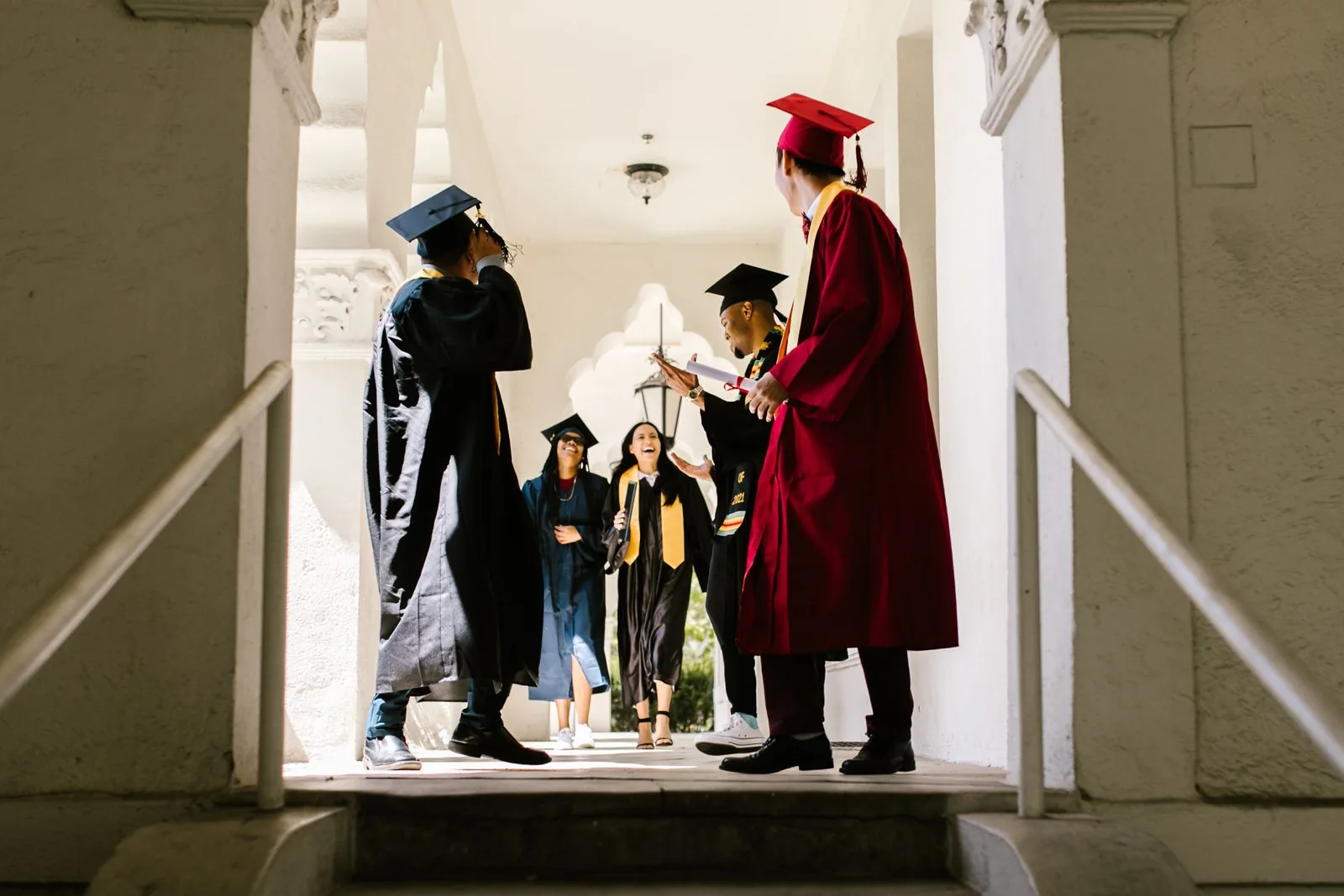 Graduates celebrating in a university hallway