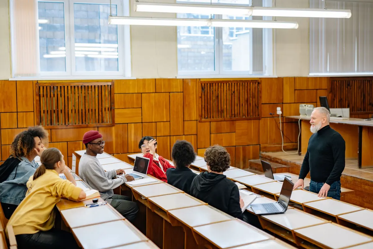 University students discussing a topic with their instructor